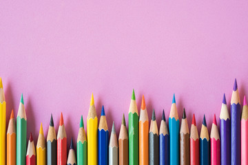 coloring pencils on a pink background