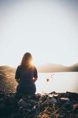 The silhouette of woman sitting alone, concept of lonely, sad, alone, person space, alone and scared