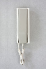 Wall phone on gray background.