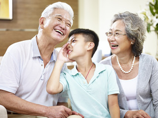 asian grand parents and grandchild having fun