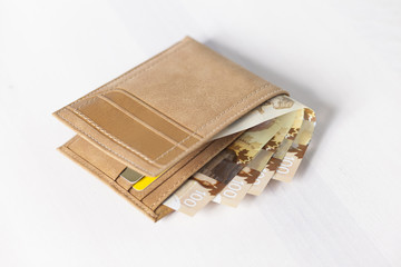 Canadian Dollars and credit cards in mustard coloured leather wallet
