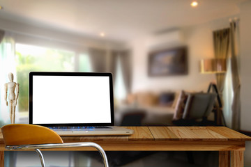 Mock up Blank screen Laptop on wooden table in liveing room.