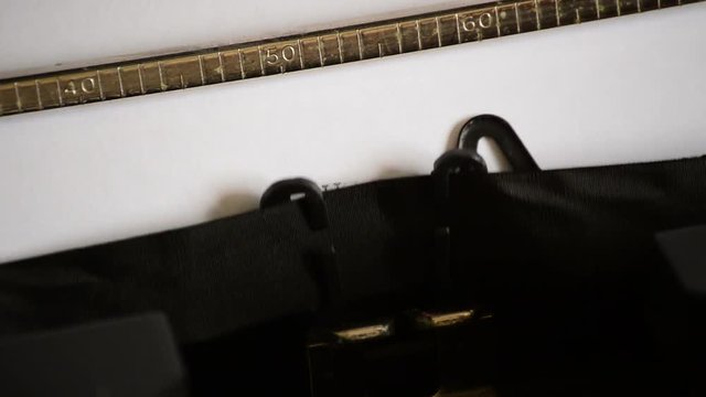 Typing the expression BUSINESS PLAN with an old manual typewriter