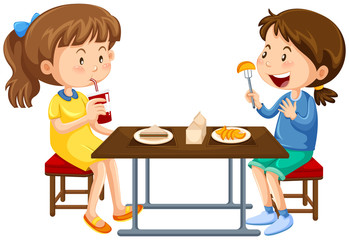 Two girls eating on picnic table