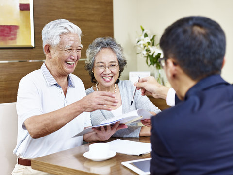 senior asian couples ready to sign contract