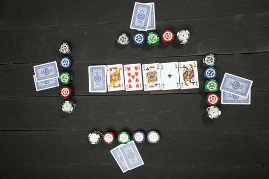 Playing poker on black wooden table