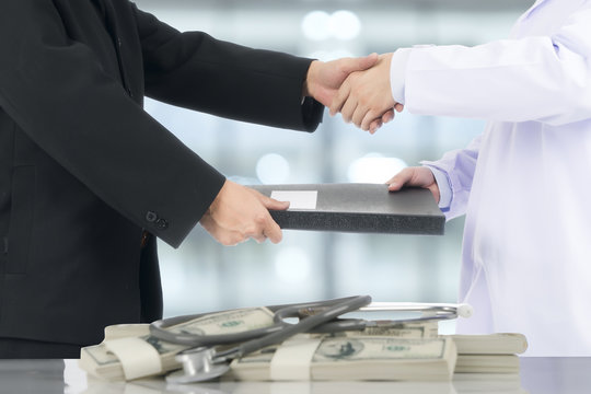 Businessman Handshake To Deal With The Doctor.