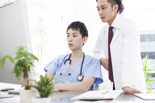 Two male doctors are talking at the examination room