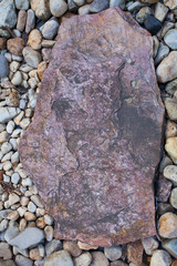 Color pebble stone in background with flat rock in middle