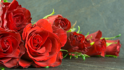 Red roses on slate,  Background