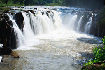 waterfall in Laos with red water