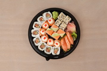 Set of assorted sushi kept in a black round box