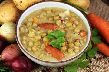 Light summer green pea cream soup in bowl
