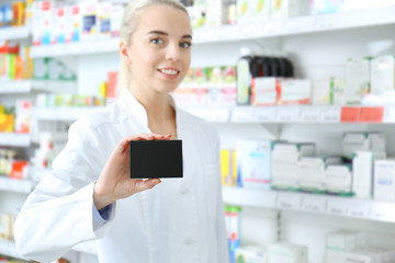 Female shop assistant with cardboard package at work