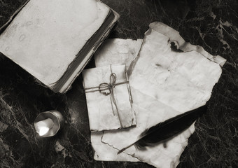 aged retro papers and book on table with detective tools backgro