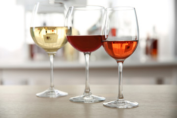 Three glasses with wine on kitchen table