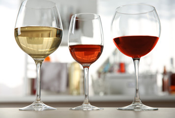 Three glasses with wine on kitchen table