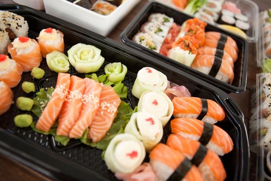 Assorted sushi set served in plastic boxes