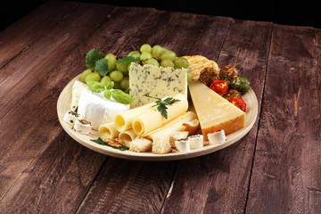 Cheese platter with different cheese and grapes