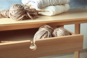 Obraz na płótnie Canvas Balls of knitting yarn in table drawer