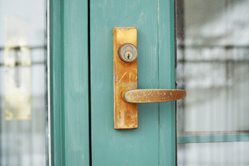 close up on rustic old door lock and handle
