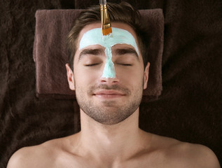 Man having cosmetic mask in spa salon