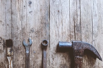 hammer and wrench with wood background