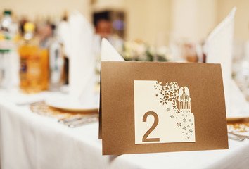Obraz na płótnie Canvas Brown board with the number of the wedding table