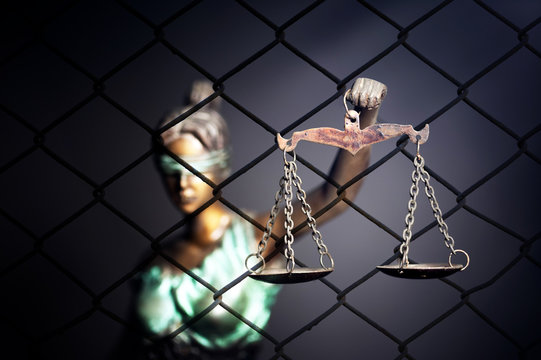 Lady Justice against cage background