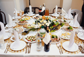 Well-decorated wedding table with the bouquet of flowers