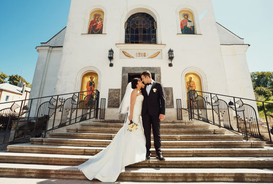 Nice couple on the stairs to the church before the wedding