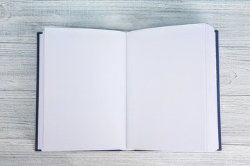 Opened book on white wooden table