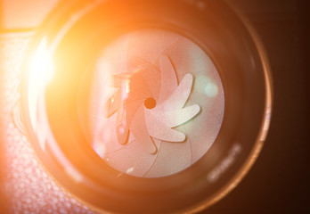 The diaphragm of a camera lens aperture with sunlight effect. Selective focus with shallow depth of field.