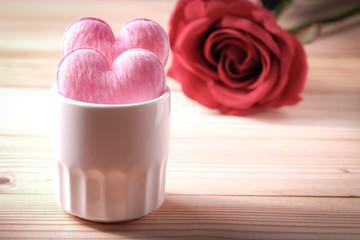 2 hearts in white glass on the wooden floor. Valentine's Day Concept
