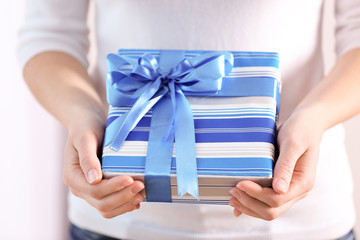 Female hands holding gift box, closeup