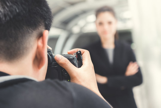 Photographer taking picture of businesswoman