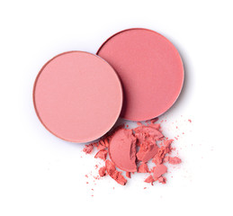 Round pink blusher and crashed eyeshadow for makeup as sample of cosmetic product
