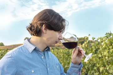 Winemaker tasting his wine in vineyard