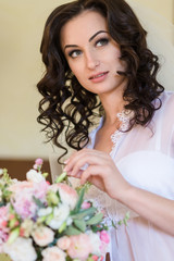 Beautiful young bride in lingerie. Last preparations for the waiting groom