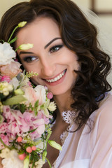 Beautiful young bride in lingerie. Last preparations for the waiting groom