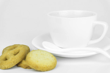 Coffee cup and candy on white background.