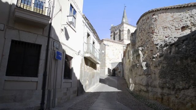 Medieval church next to the remains of the old defensive wall in the historic center of Zamora. Pan motion

