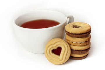 Cup of tea and cookie with heart-shaped filling