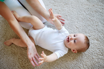 happy mother playing with baby at home