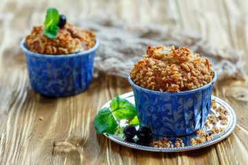 Homemade muffins with blackberry and a sprig of mint.