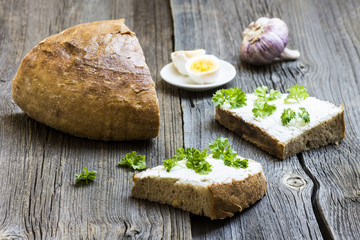 Fresh Bread Slices with Garlic and Egg on Wooden Background