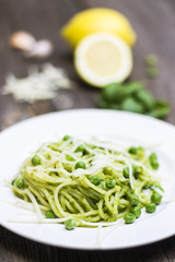 Spaghetti Pasta with Peas on Wooden Background