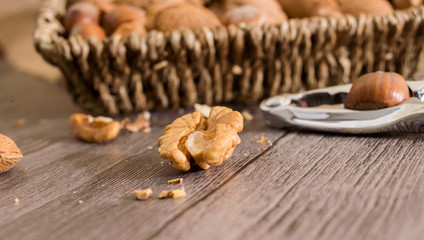 Fototapeta na wymiar delicious assortment of nuts in a woven basket on wooden backgro