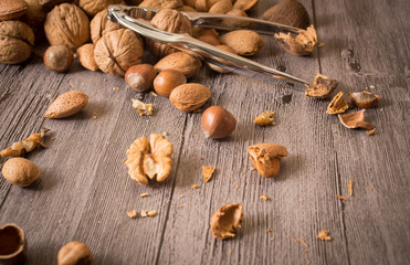 Delicious assortment of nuts on wooden background