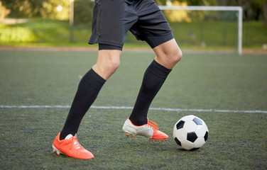 soccer player playing with ball on football field